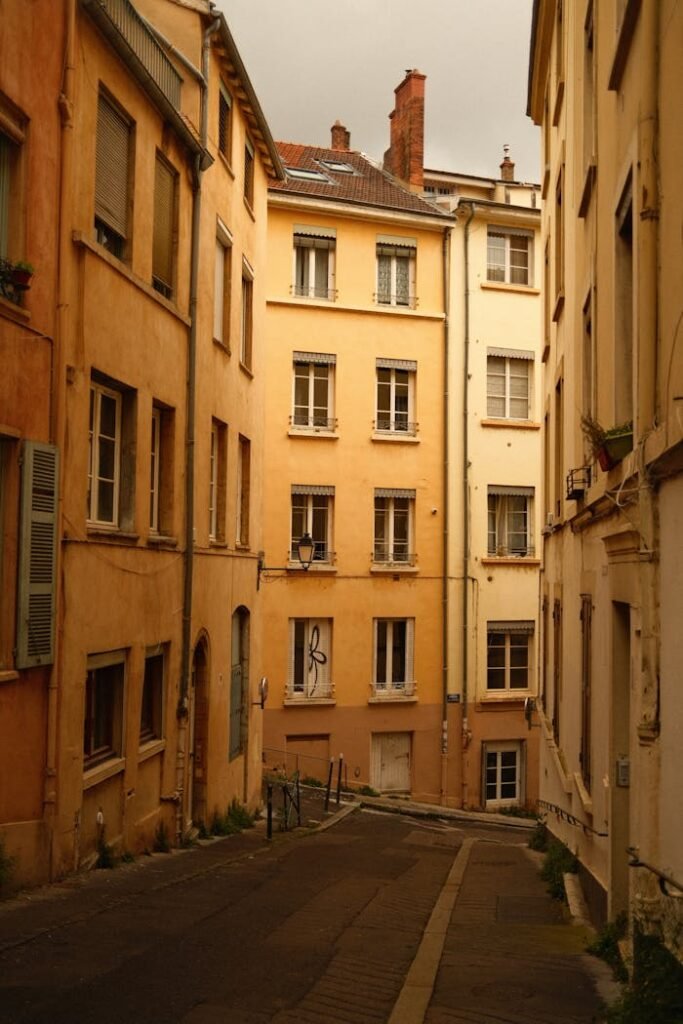 Charming narrow street in lyon showcasing classic french architecture under warm light.